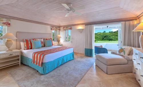 a bedroom with a bed and a chair and a couch at Coconut Grove 2, Royal Westmoreland by Island Villas in Saint James