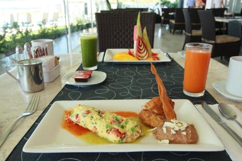 a table with a plate of food on a table at Park Royal Beach Mazatlán in Mazatlán