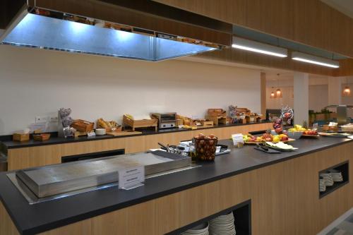 a kitchen with a counter with food on it at Ohasis Boutique Suites in Los Cristianos