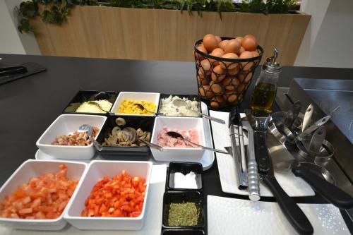 a table with several dishes of food on a table at Ohasis Boutique Suites in Los Cristianos