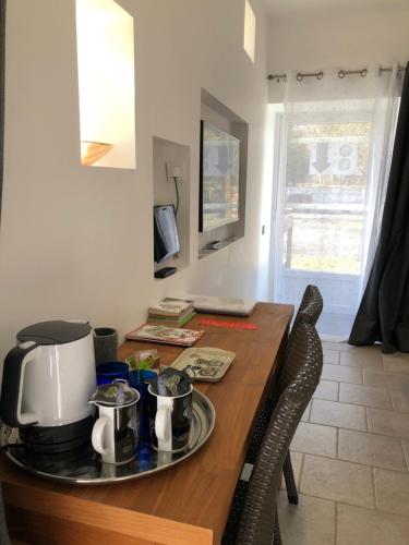 a kitchen with a table with a coffee maker on it at Chambre Pomme Cannelle Premium Aux portes de Bayeux Normandie 2 pers in Monceaux-en-Bessin