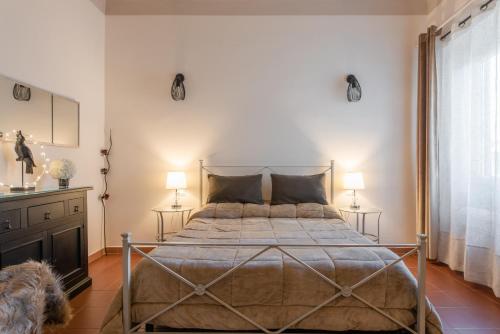 a bedroom with a large bed with two lamps at Dante Experience Apartment in Florence