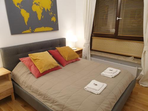 a bed in a room with two towels on it at Warsaw Apartment Sarmacka in Warsaw