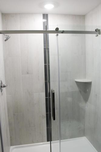 a shower with a glass door in a bathroom at Best Western Plus Morden in Morden