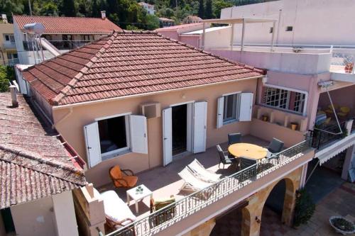 a balcony of a house with a table and chairs at Casa di Vito, 10m from Sami's main square in Sami