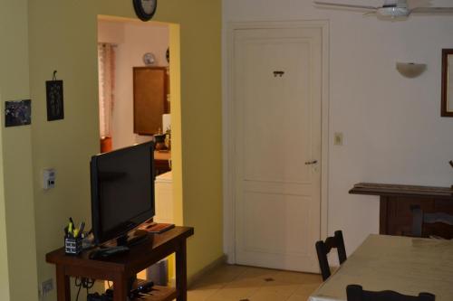 a living room with a television on a table with a door at SL 1908 in Olivos