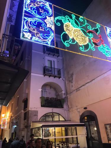 a lit up sign on the side of a building at B&B IN CENTRO STORICO SALERNO in Salerno