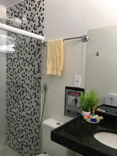 a bathroom with a shower and a toilet and a sink at Chalé Temporada Porto dos Lençóis - Lençóis Maranhenses in Barreirinhas
