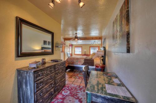 a living room with a dresser and a bedroom at Cali Cochitta Vacation Rentals in Moab