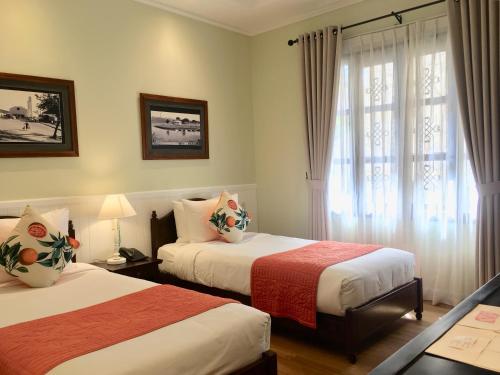 Postel nebo postele na pokoji v ubytování BICH DAO Boutique - Dalat