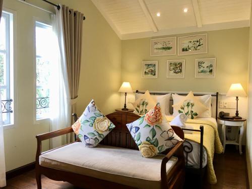 a bedroom with a bed and a window at BICH DAO Boutique - Dalat in Da Lat