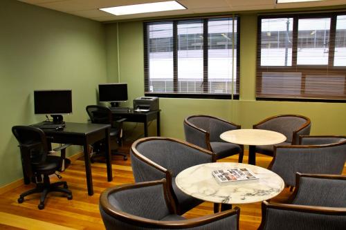 a waiting room with chairs and tables and windows at Days Inn by Wyndham Vancouver Downtown in Vancouver