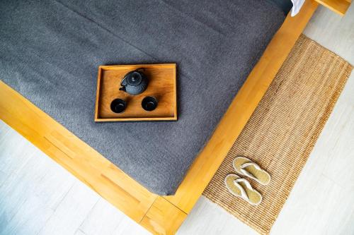 an overhead view of a pair of headphones and two pairs of shoes at Villa Kyoto in Layan Beach