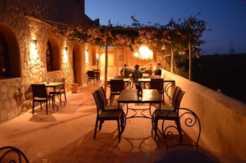 a table and chairs on a patio at night at Dar Essaada in Essaouira