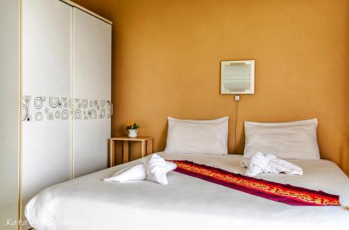 a bed with white sheets and pillows on it at KATA PENTHOUSE SEA VIEW private POOL in Kata Beach