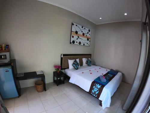 Gili Palms Resort tesisinde bir odada yatak veya yataklar
