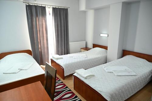 Postel nebo postele na pokoji v ubytování Harmony Hotel
