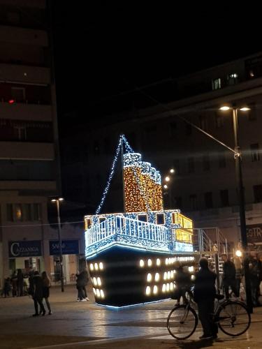 a large boat covered in lights on a street at Blue Apartment in Pescara