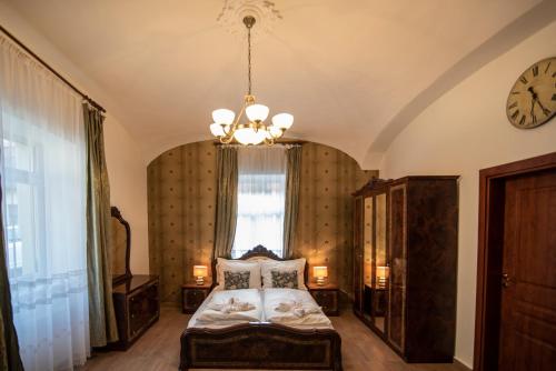 a bedroom with a bed and a clock on the wall at My-Lord LuxApartman in Eger