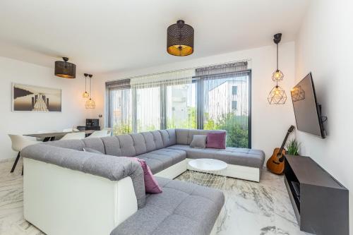 a living room with a couch and a table at Luxury apartment NOA in Njivice