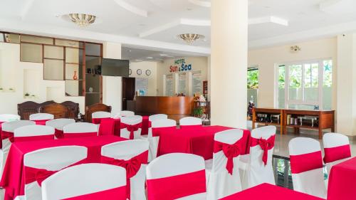 a room with red and white tables and chairs at Sun & Sea Hotel in Phu Quoc