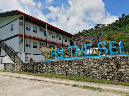 a building with a wall with graffiti on it at By The Sea Hotel Bulalacao in Bulalakao