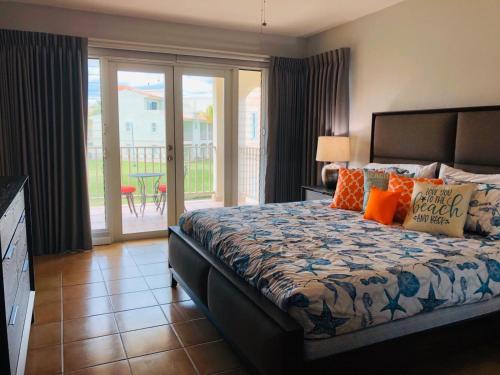 a bedroom with a bed and a balcony at Mariposa Beach House in Humacao