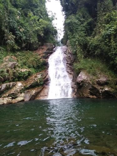 a waterfall in the middle of a river at Ha Giang Faithien Homestay in Ha Giang