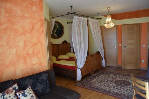 a bedroom with a bed and a chandelier at Kerndlerhof in Ybbs an der Donau