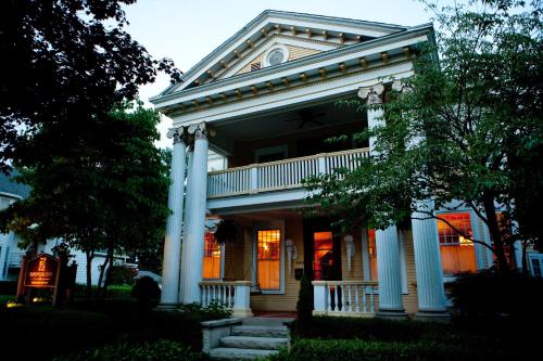 a large house with columns and a porch at Showers Inn in Bloomington