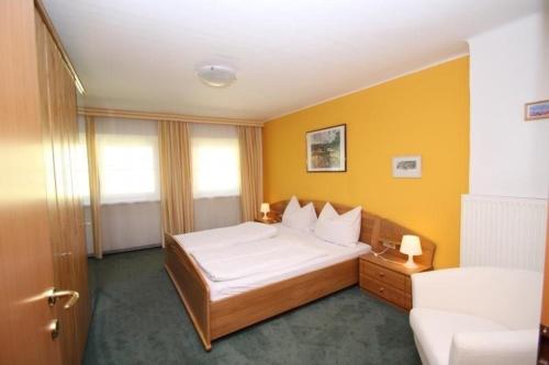a hotel room with a bed and a couch at Pension Reiterhaus in Wagrain