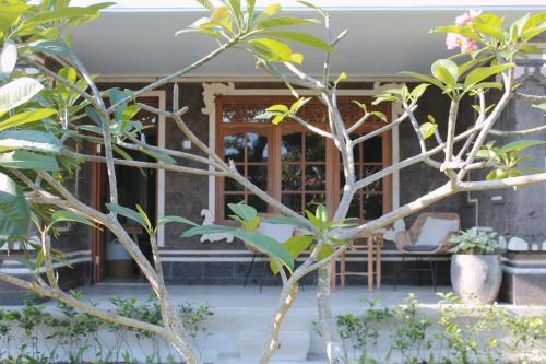 a house with a bunch of trees in front of it at The Inn Possible in Uluwatu