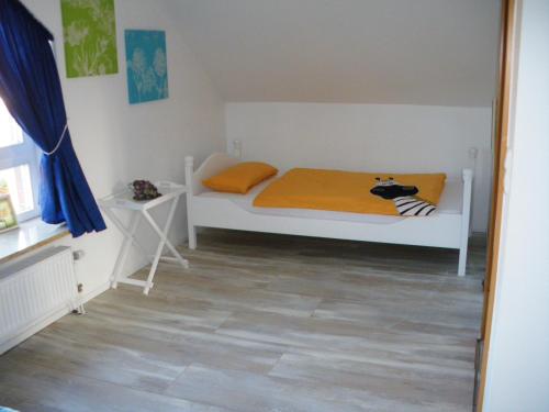 a bedroom with a bed with a cow pillow on it at Ferienwohnung am Jordan in Schneverdingen