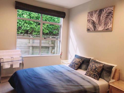 a bedroom with a bed in front of a window at Mia Cosy Holiday Home in Rotorua