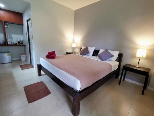 a bedroom with a bed with a red stuffed animal on it at SER-EN-DIP-I-TY - SHA Extra Plus in Ko Lanta
