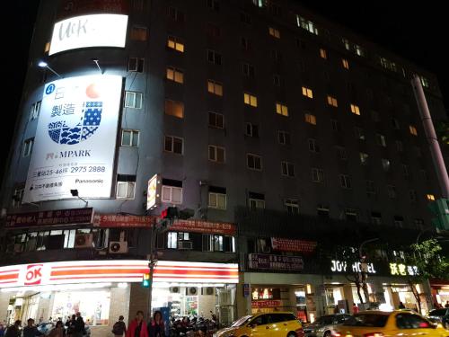 a building with a large sign on the side of it at Walker Hotel - Sanchong in Taipei