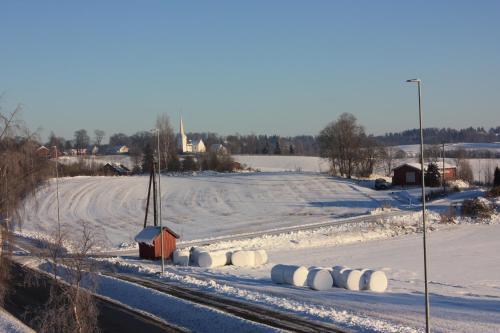 a snowy field with hay bales in the snow at Bedder at Oslo Airport - serviced apartments in Jessheim