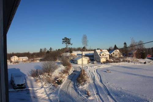 a view of a snow covered street with houses at Bedder at Oslo Airport - serviced apartments in Jessheim
