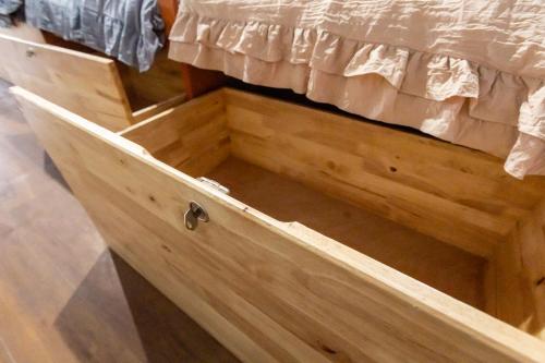 a wooden dresser with a drawer under a bed at Aladdin Guest House in Phi Phi Don