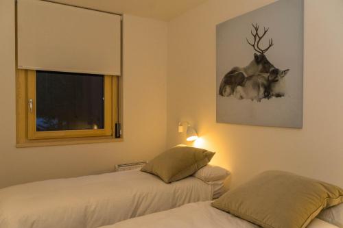 a bedroom with two beds and a picture of a deer at Airoto by Totiaran in Baqueira-Beret