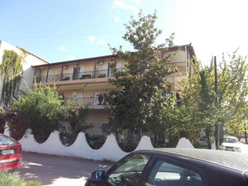 a building with a car parked in front of it at LUXURIOUS APPARTMENTS KATERINA in Platamonas