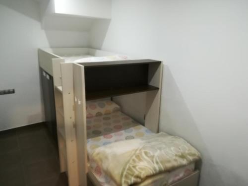 a small shelf in a room with a bed at Vivienda de uso turístico, A Casa Do Campo in Fisterra