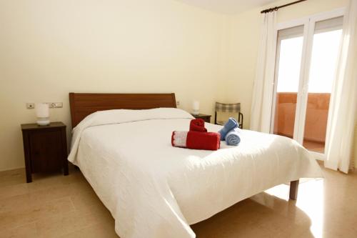 un dormitorio con una cama con un animal de peluche en REF 1 Spacious Sea View Apartment, en Marbella