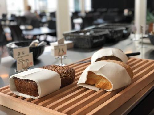two loaves of bread sitting on a cutting board at Hotel GSH in Rønne