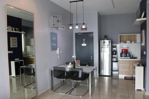 a kitchen with a table and chairs and a refrigerator at HNM Homestay Mesahill Nilai KLIA in Nilai