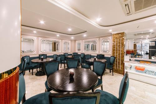 a dining room with tables and chairs at Saigon Hanoi Central Hotel in Ho Chi Minh City