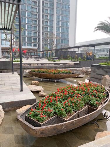 two wooden boats filled with flowers in a park at Serviced Apartment in Metropolis near Lotte and Daewoo Hanoi in Hanoi
