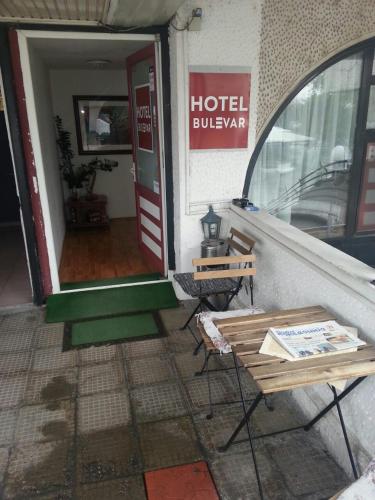 a door to a hotel lobby with two chairs outside at The Bulevard Hotel in Skopje