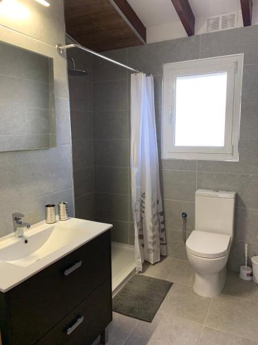 a bathroom with a sink and a toilet and a window at Ca Liberty in Moraira