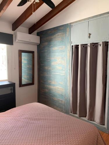 a bedroom with a bed and a wooden wall at Ca Liberty in Moraira